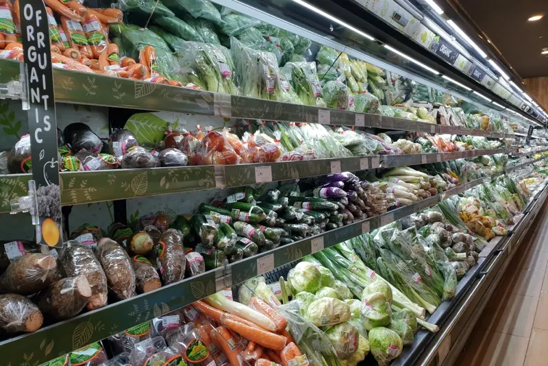 Interior view of the huge refrigerator with various fresh vegetables - Large grocery chain