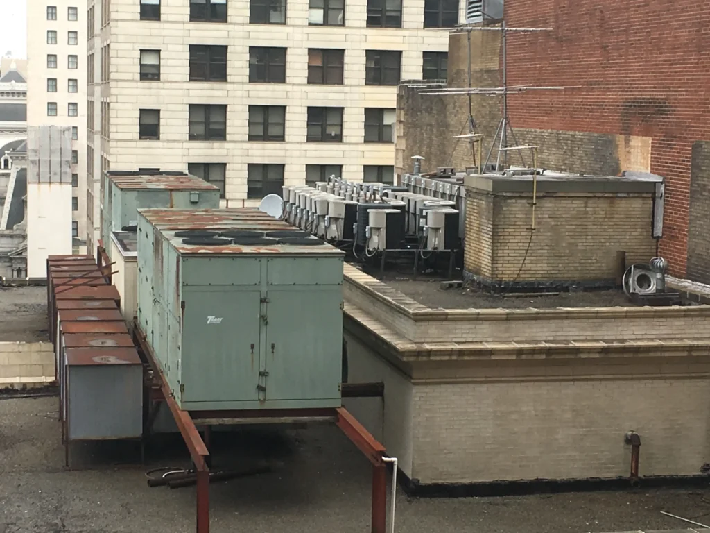 Refrigerant unit installed on the rooftop of a building in a cityscape setting