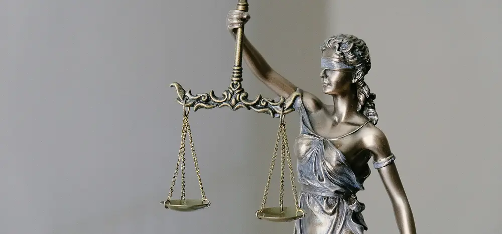 Bronze statue of Lady Justice wearing a blindfold and holding scales, symbolizing law, justice and balance. Feminine figure in classical style often seen in U.S. courthouses