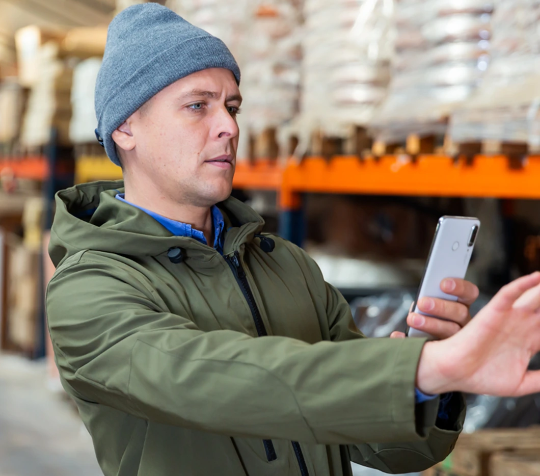 Man using his mobile phone to tag assets and detect refrigerant leaks-TW
