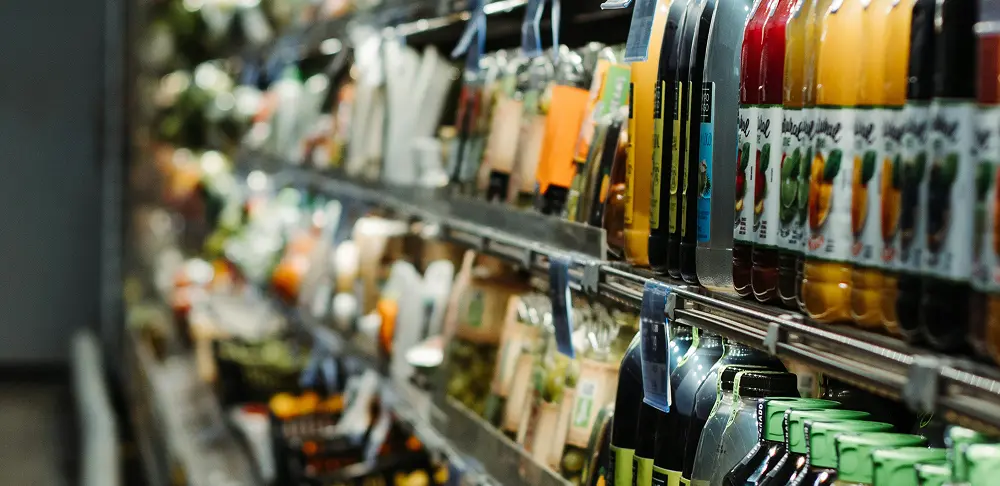 Close-up of a supermarket refrigerator stocked with juice bottles