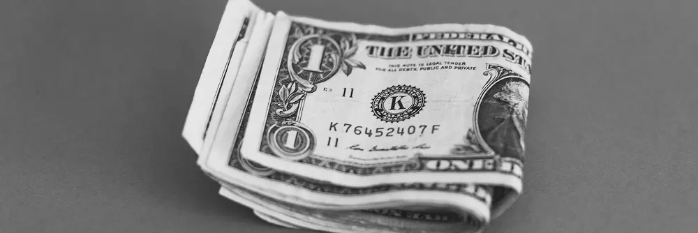 Stack of one-dollar bills placed on a table
