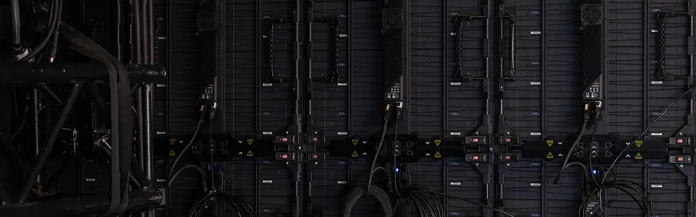 Close-up view of black data center cables on dark server cabinets
