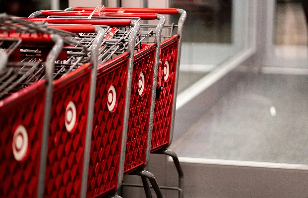 Close-up view of red Target shopping carts lined up outside a supermarket, with the Target logo visible on the carts