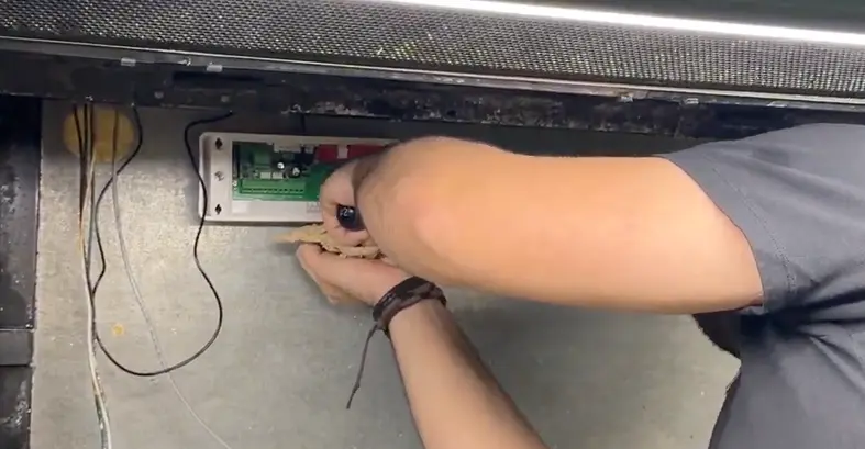 A technician is installing an AKO leak detector in a grocery store