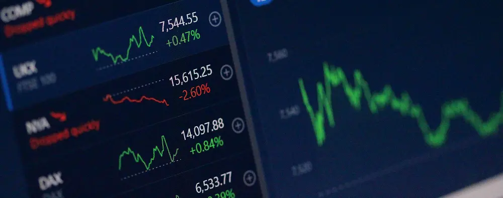 Image representing market trends with multiple red and green graphs