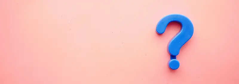 Blue Question Mark on a light pink background