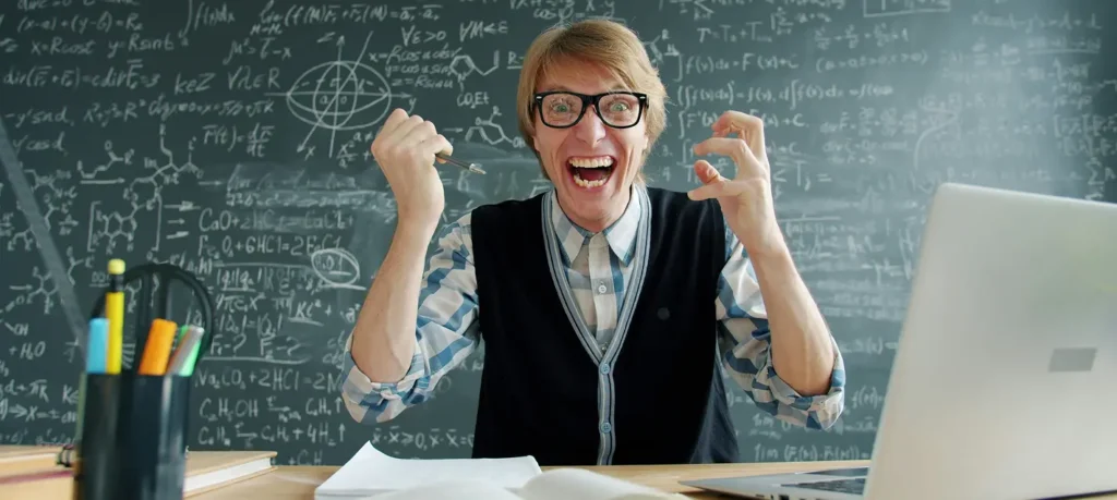 A teacher sitting at his desk, appearing visibly frustrated and stressed because he cannot solve a math problem on the dashboard