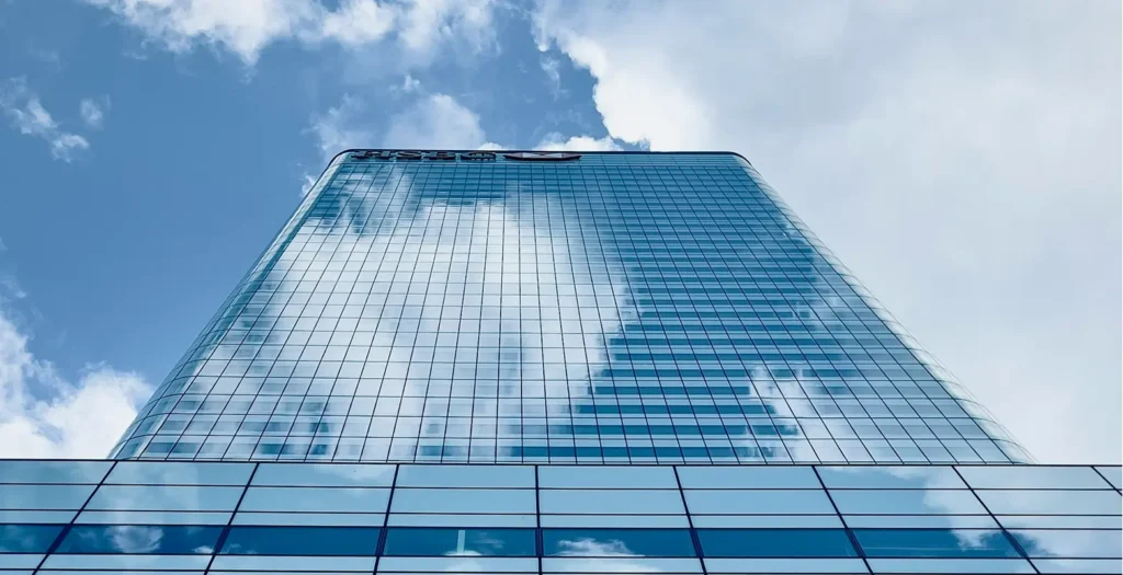 corporate building reflecting blue sky illustrating leak detection regulations