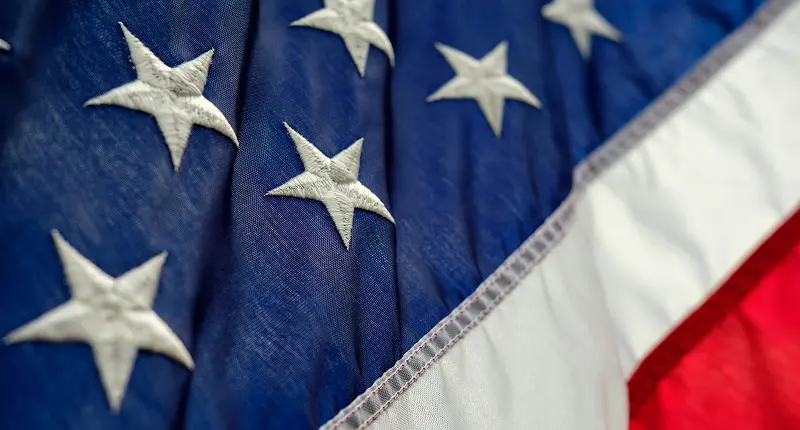 Close-up of the United States flag with red and white stripes and white stars on blue