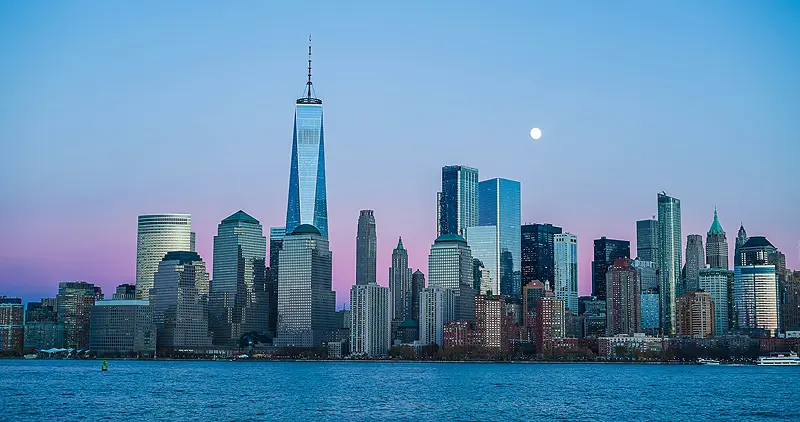 The New Jersey skyline silhouetted against a purple and blue sunset sky